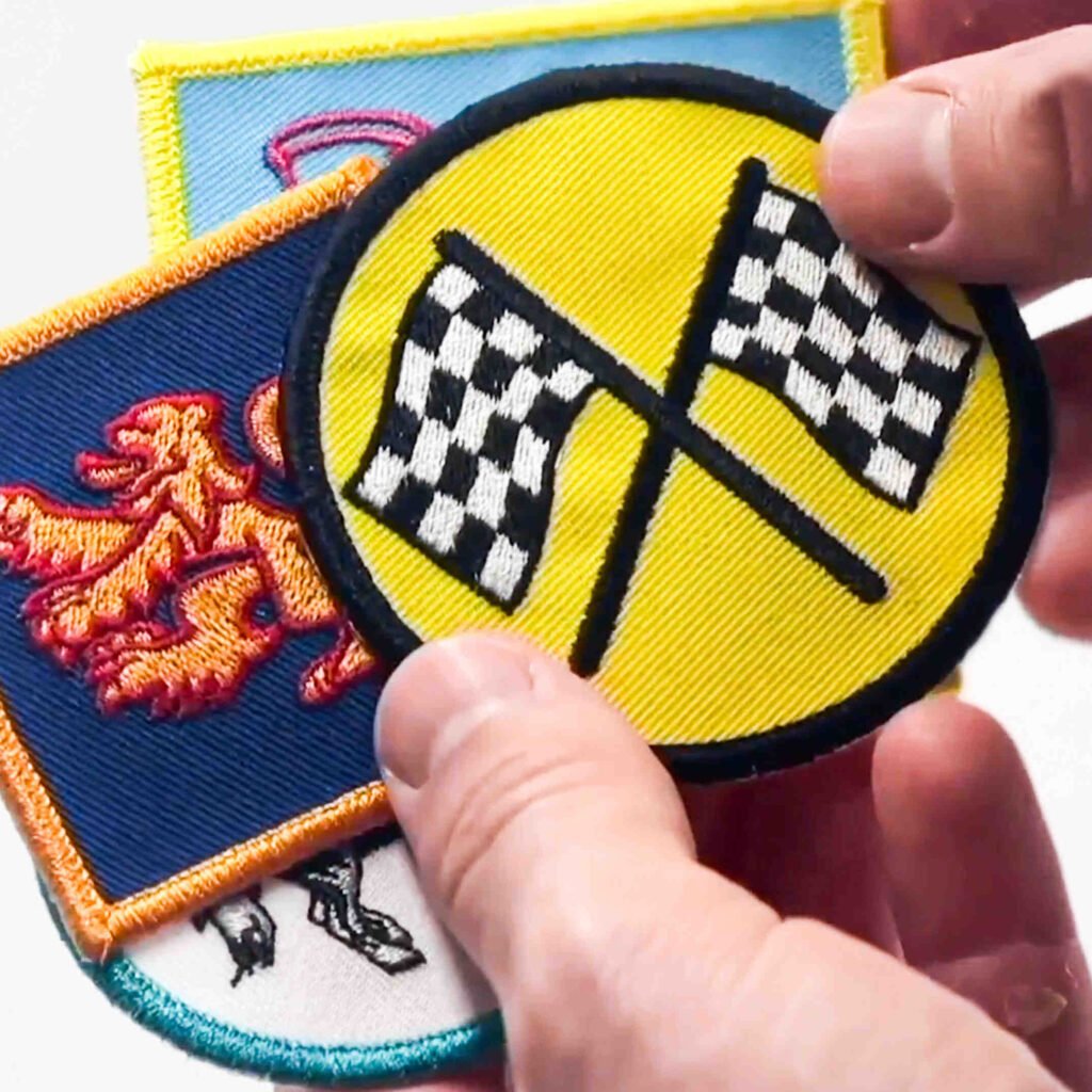 holding-embroidery-patches Hand holding various embroidery patches